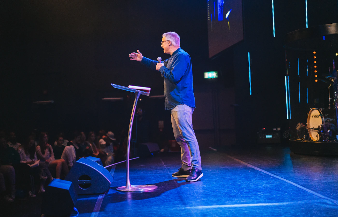 Pastor teaching on stage in front of the congregation