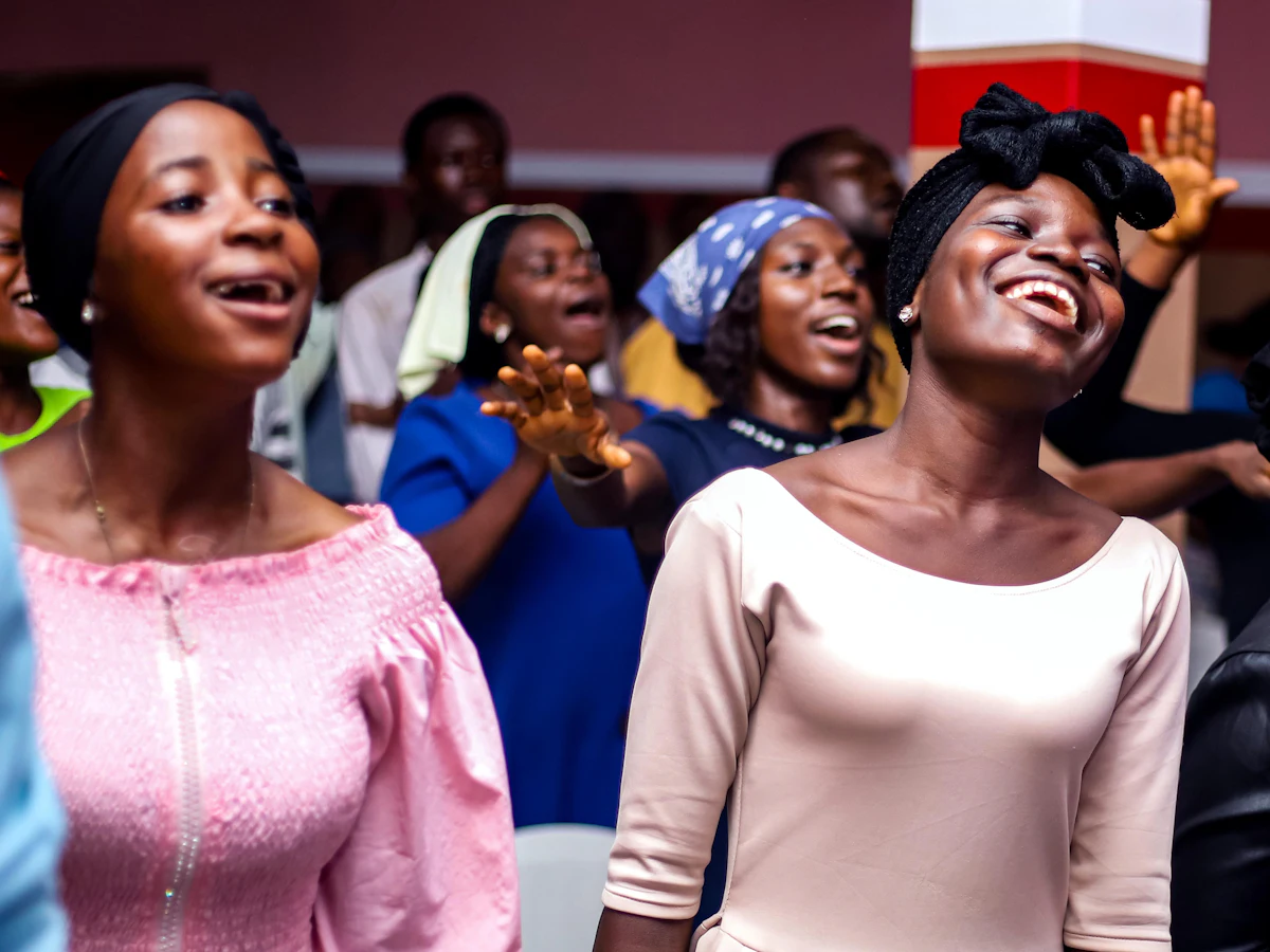 Women singing joyfully during worship