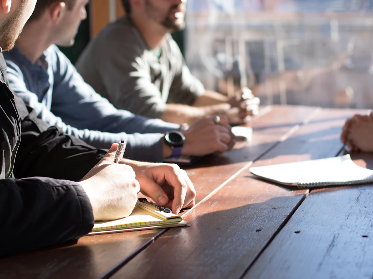 Group with open Bibles around a wooden table