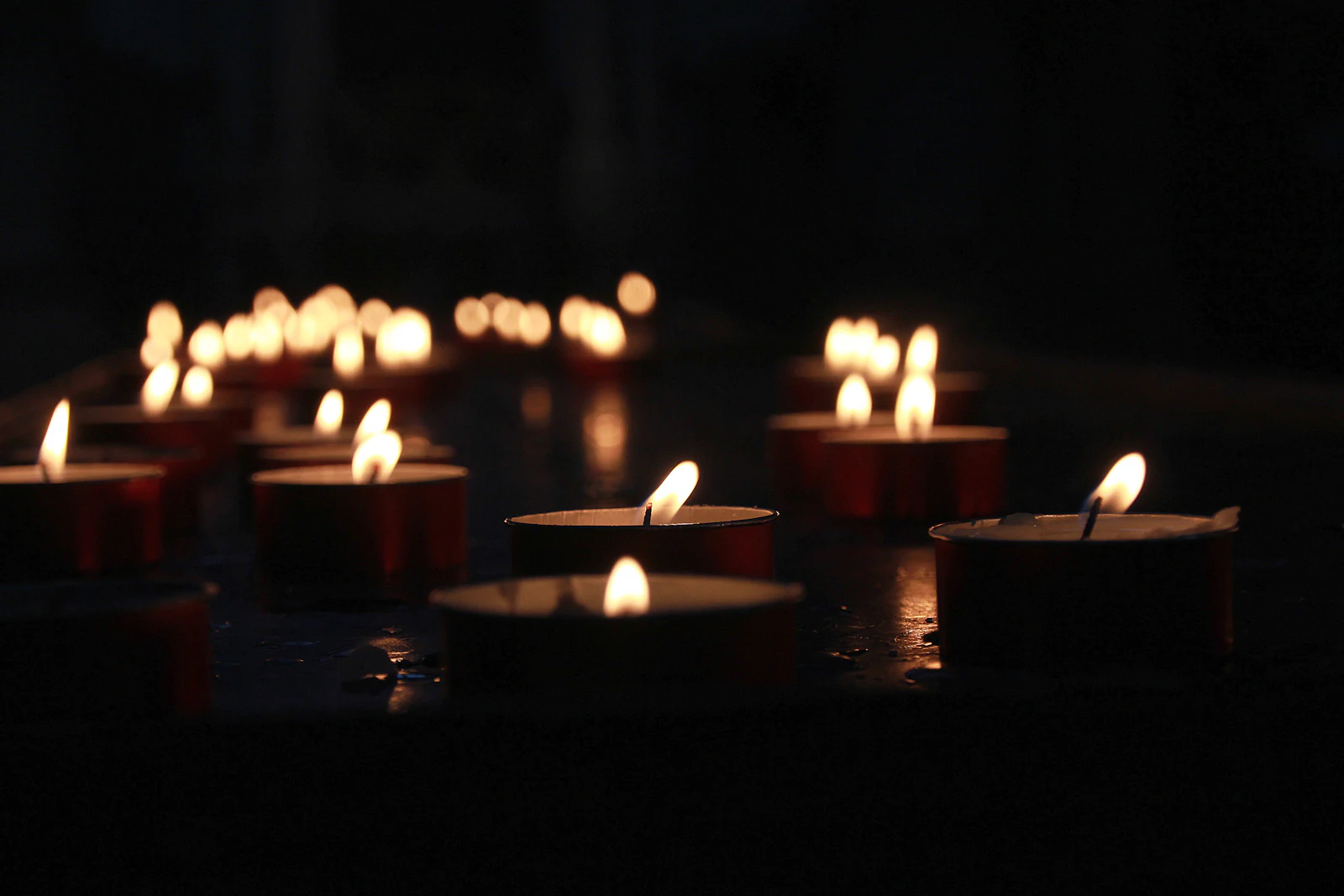 Rows of softly glowing memorial candles