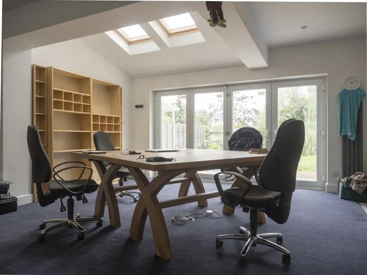 The firm's conference room with a timber table and garden doors