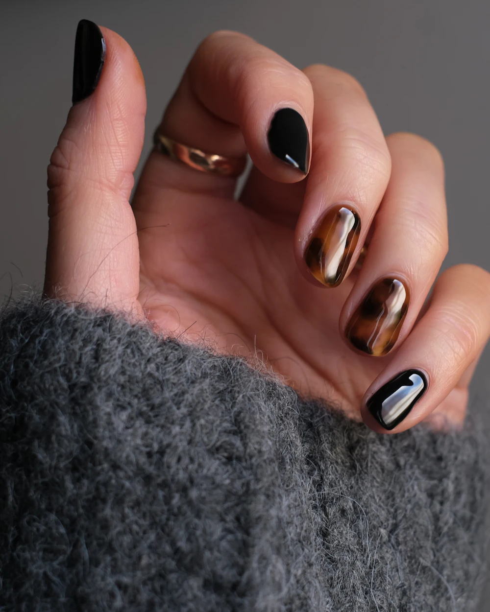 Long glossy dark nails with gold accent art