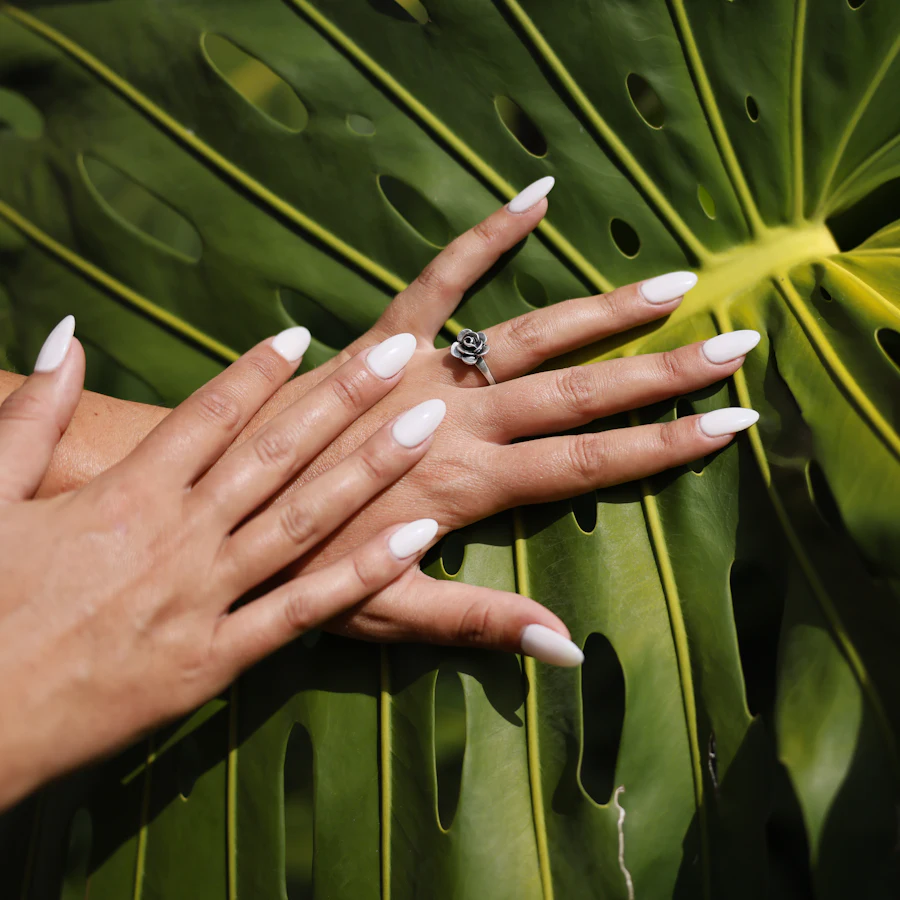 Glossy white nails on a monstera leaf