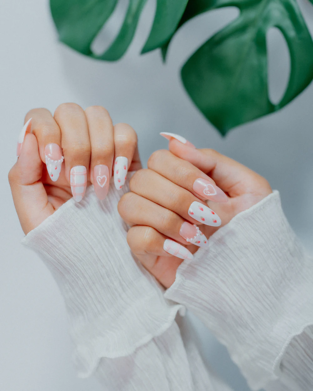 Delicate white and nude nail art with fine details