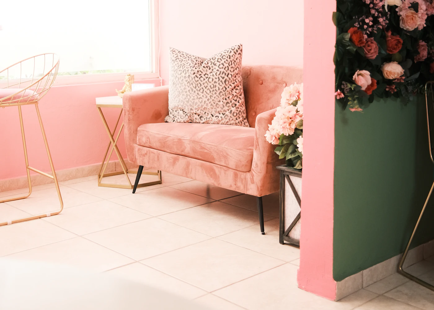 Blush lounge with velvet sofa and flowers