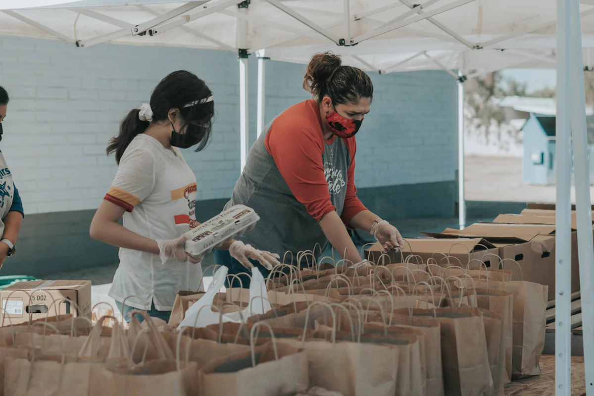 Volunteers packing grocery bags for delivery