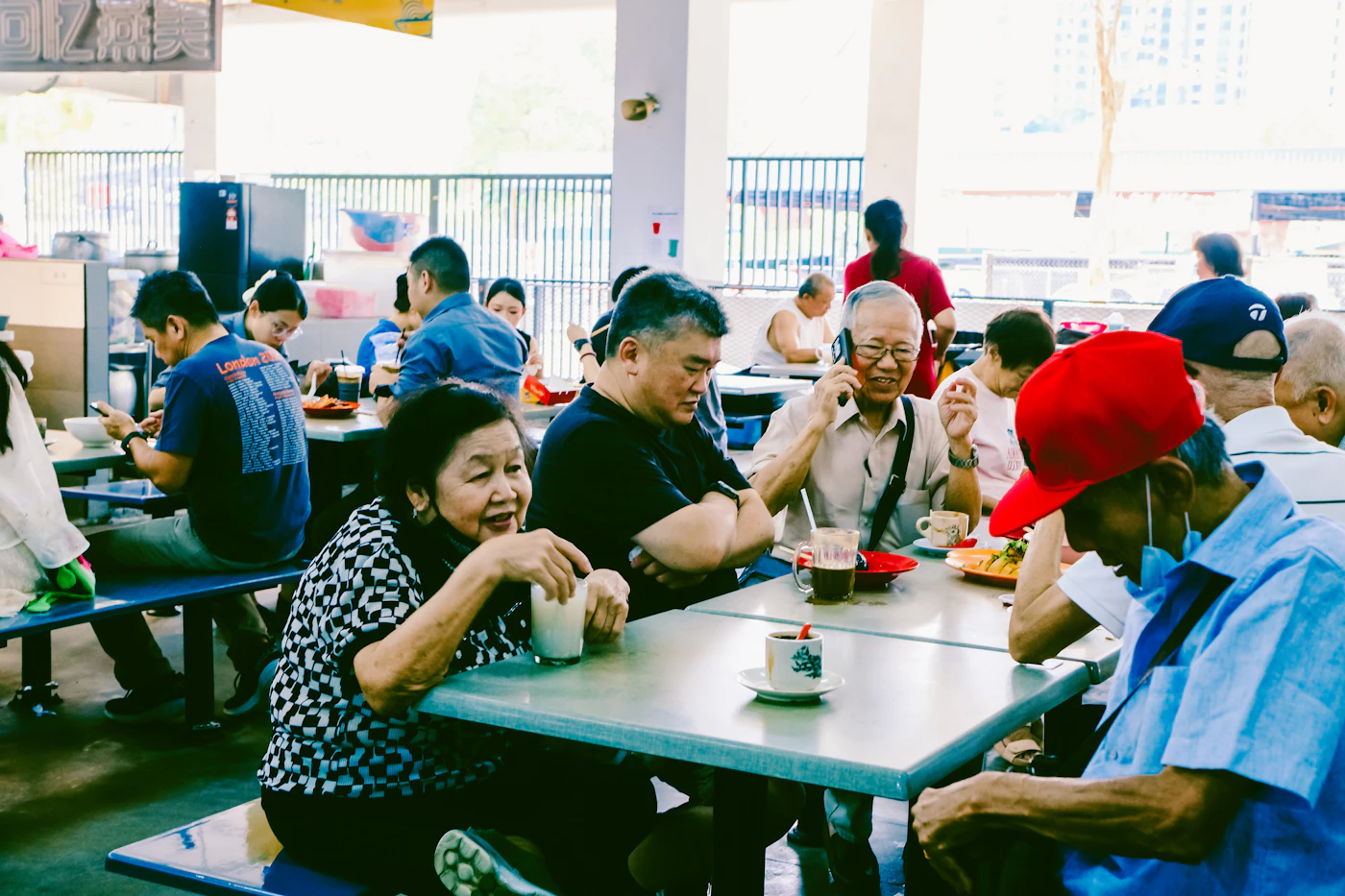 Neighbors sharing a hot community meal at long tables