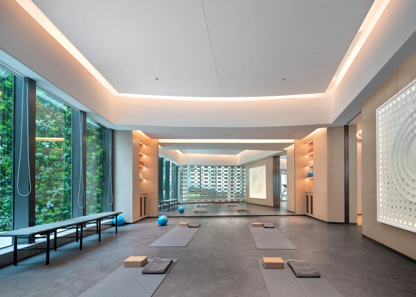 Bright, minimal Pilates studio with wood floors