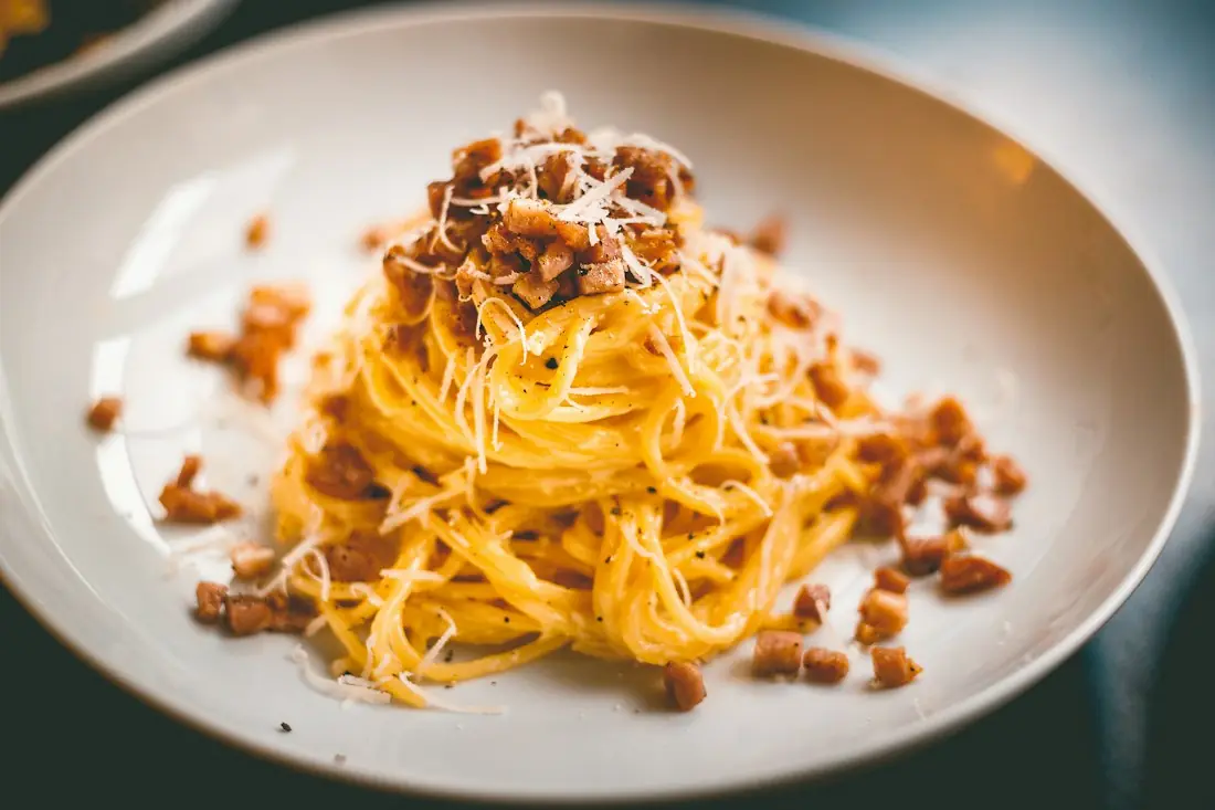 Spaghetti twirled high in a white bowl