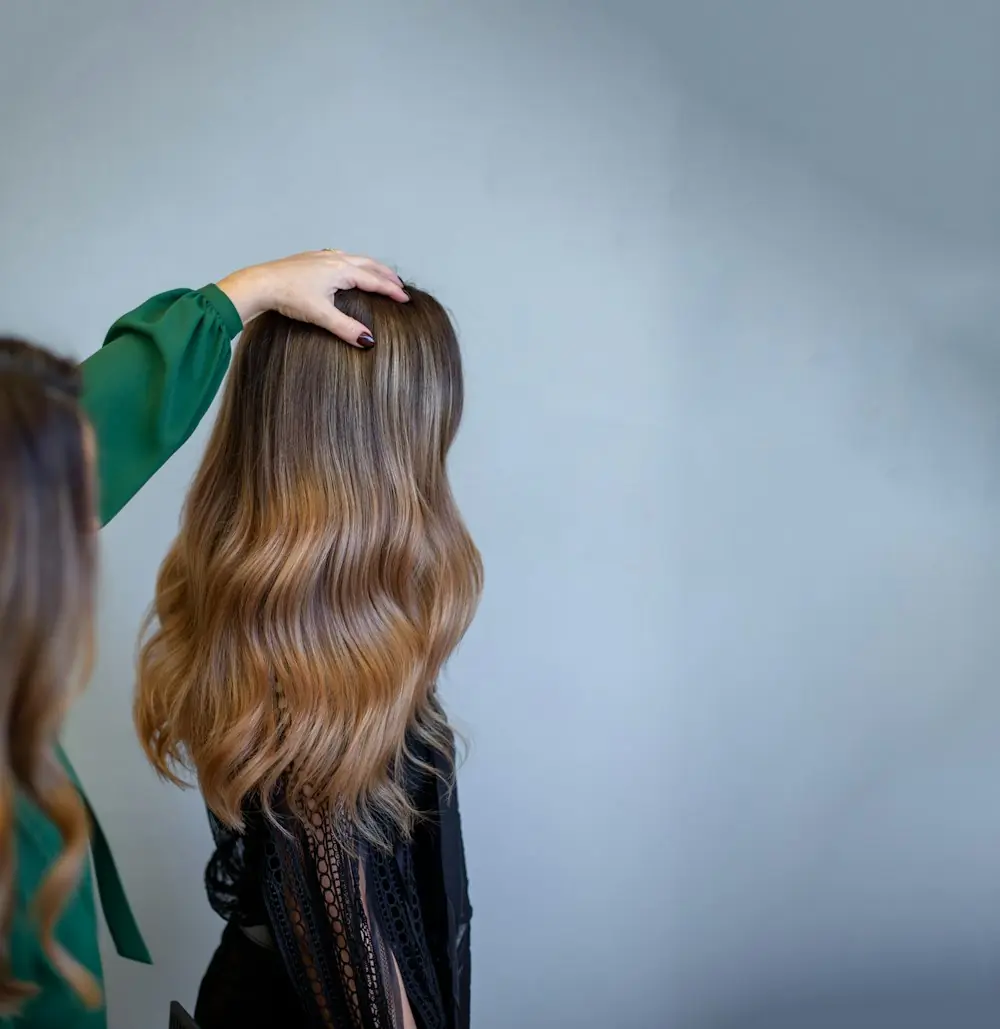 Long waves with soft caramel balayage, seen from behind